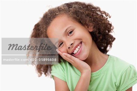 Cute girl with her hand on her cheek against a white background