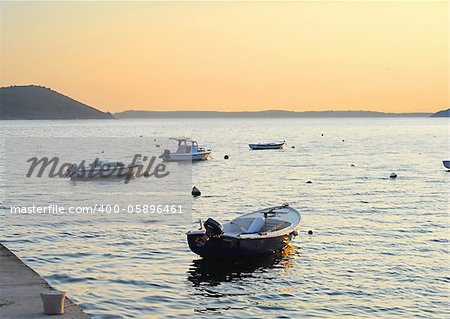 Fishing boats in Herceg Novi harbor at sunset. Montenegro