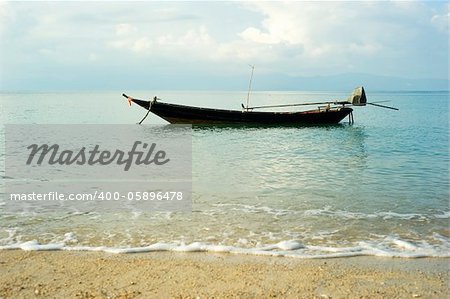 Traditional thailand boat  in the sea at sunrise