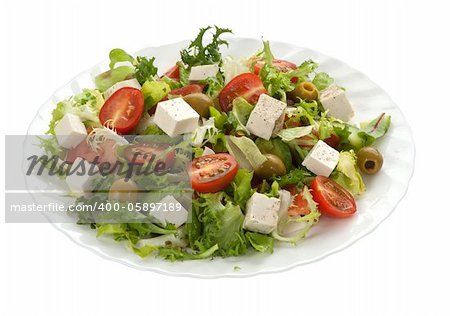 green salad with feta cheese isolated on white