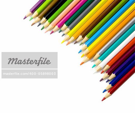 Multi colored pencils in a corner on a white background