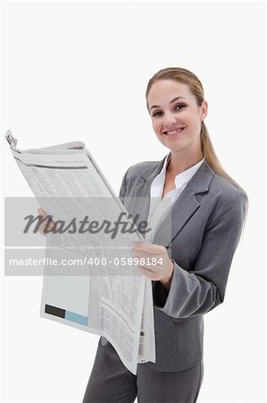 Portrait of a happy businesswoman reading the news against a white background