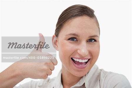 Businesswoman with the thumb up against a white background