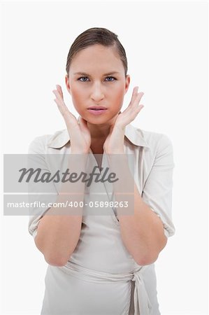 Portrait of a businesswoman with her hands around her face against a white background