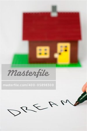 Hand write text Dream and house on background.