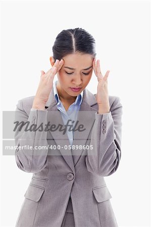 Portrait of a beautiful businesswoman having a headache against a white background