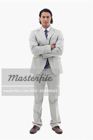 Portrait of an office worker posing with the arms crossed against a white background