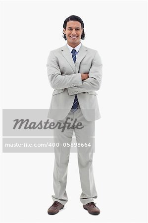 Portrait of a smiling office worker posing with the arms crossed against a white background