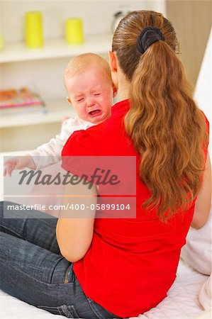 Mother calming crying baby