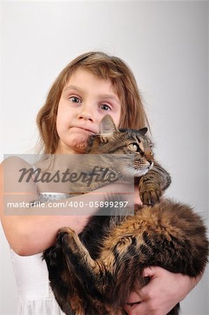 close-up portrait of a little girl holding her cat