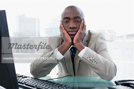 Bored businessman posing in his office