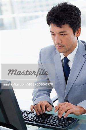 Portrait of a serious manager using a computer in his office