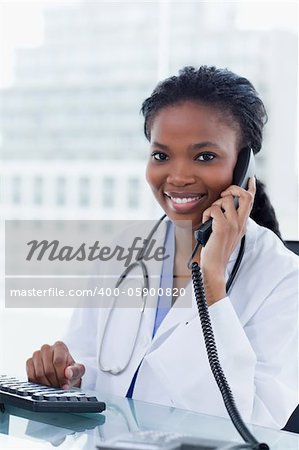 Portrait of a female doctor on the phone in her office