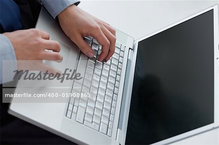 Angle view of hands typing on a laptop