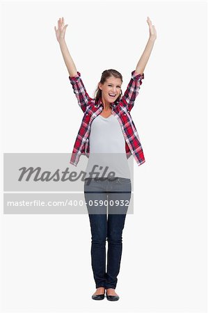 Portrait of a woman with the arms up against a white background