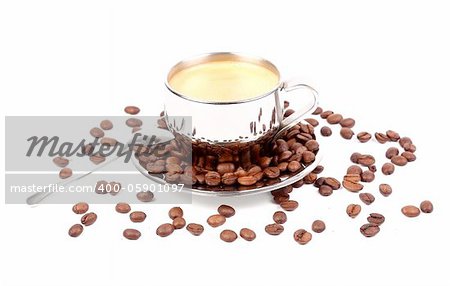 metal Cup of espresso coffee with spoon and seeds on the white background
