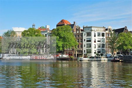 Amsterdam. Beautiful old buildings on the  the river Amstel embankment