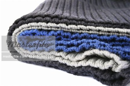 Knitted colorful wool cloths on white background.