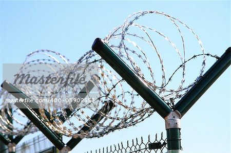 barbed wire against blue sky as nice army background