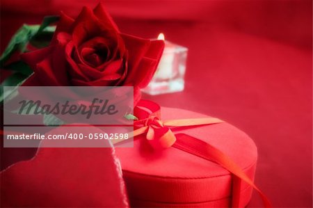 Valentine's day red heart on luxury present candle and copyspace