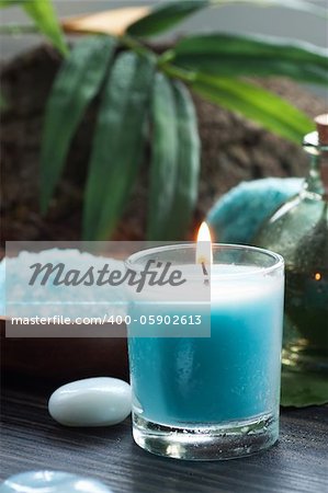 Spa and wellness  setting with bath salt, candles and towel. Blue dayspa nature set