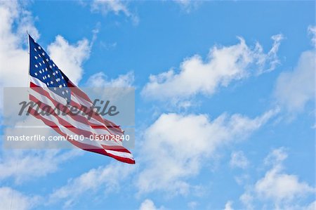 American flag on a blue sky during a windy day