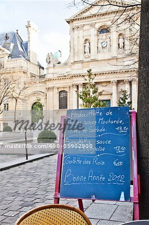 Black board with a menu restaurant in a tipical traditional square in Paris