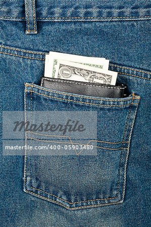 Black leather wallet with dollars in jeans pocket