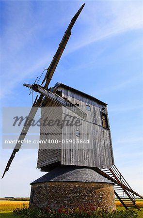 Traditional wooden windmill in France in the Eure &Loir Valley region.This is "moulin Barbier" mill.The image is intentionally deformated a little.