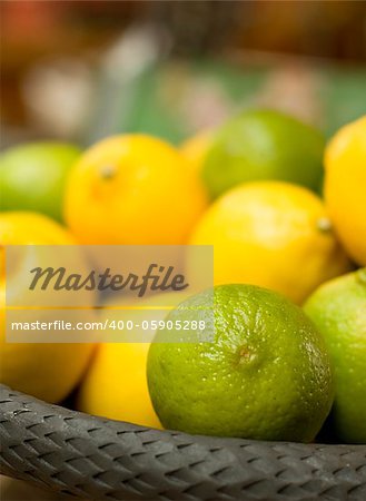 Basket full with green and yellow citrus fruits