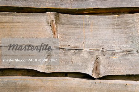 Wooden village house walls carved planks closeup background.