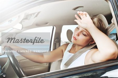 portrait of young beautiful woman sitting in the car