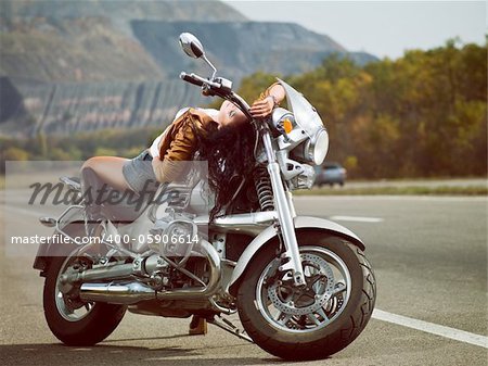 Girl on a motorcycle on the road in an outdoor