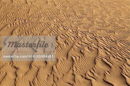 Close up image of wave patterns in sand dune in the desert.