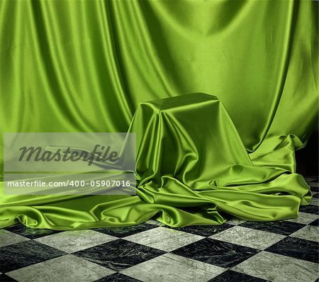 Something secret veiled under green satin silky cloth fabric