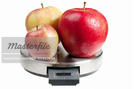 Three red apples on a scales isolated over white background. Diet concept