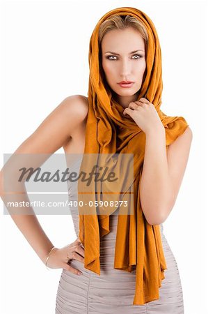 elegant pretty young woman with a long scarf and a lighter dress. She is in front the camera, looks in to the lens. The right hand is on the hip and the left hand is near the neck