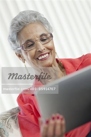 Stylish senior Black woman using a digital tablet