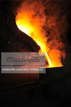 Foundry - molten metal poured from ladle for casting