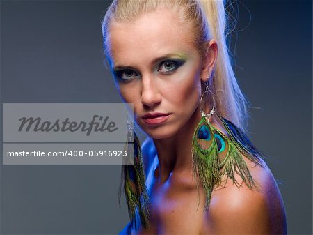 Portrait of a beautiful girl on a neutral background with blue backlight