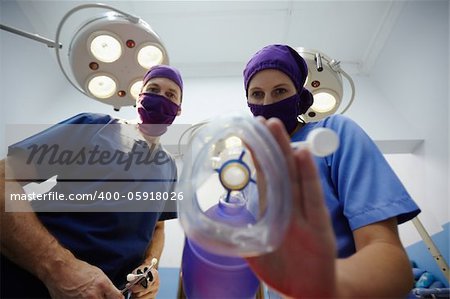 Teamwork with nurse and surgeon performing surgery in hospital operation room