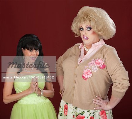 Innocent woman and disgusted drag queen over red background