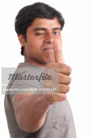 Portrait of happy young indian giving thumbs up over white background