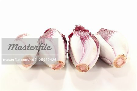 four red chicory salads on a light background