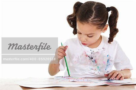 Stock image of preschooler painting with watercolors, isolated on white background