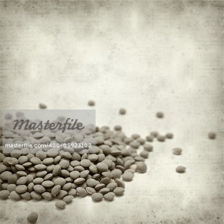 textured old paper background with brown lentils