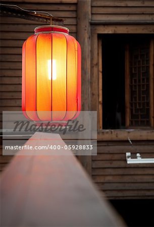 Hanging red lantern on the traditional wooden wall background