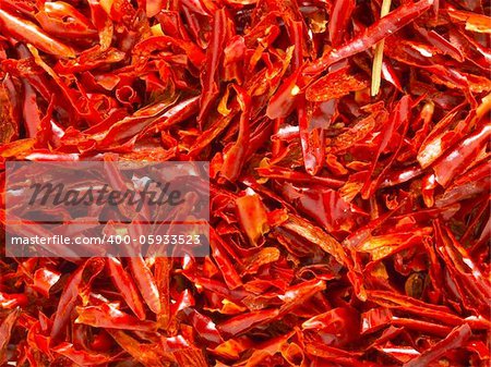 close up of red dried chili flakes food background