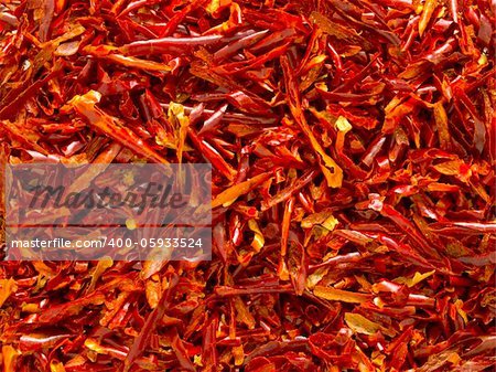 close up of dried red chili flakes food background