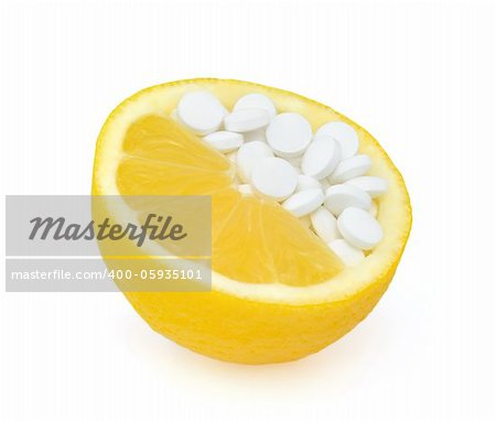 Close up of lemon and pills isolated - vitamin concept
